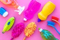 Housekeeping tool. Detergents, soap, cleaners and brush for housecleaner work on pink background top view space for text