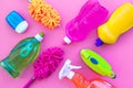 Housekeeping tool. Detergents, soap, cleaners and brush for housecleaner work on pink background top view space for text