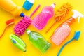 Housekeeping tool. Detergents, soap, cleaners and brush for housecleaner work on yellow background top view space for