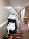 Housekeeping trolley in corridor of hotel.