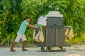 Housekeeping worker pushing the cart with cleaning tools Royalty Free Stock Photo