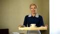 Housemaid bringing tray with coffee, good service, 5star hotel room booking Royalty Free Stock Photo