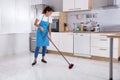 Housemaid Cleaning Floor With Broom