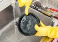 Housemaid holding dirty ashtray in the kitchen Royalty Free Stock Photo