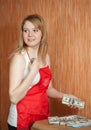 Housemaid steals money from table Royalty Free Stock Photo