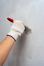 Housepainter decorating wall with paintbrush