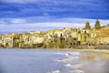 Houses along the shoreline and cathedral in background Cefalu Sicily