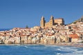 Houses along the shoreline and cathedral in background Cefalu Sicily, Italy.