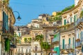 Houses with balconies overlooking a narrow street in Modica, Sicily, Italy Royalty Free Stock Photo