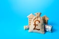 Houses and british pound sterling money bag. Asset, financial resource management. Building up capital, inflation risks. Savings. Royalty Free Stock Photo