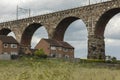 Houses built close to and under a railway viaduct Royalty Free Stock Photo