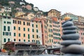 Houses of Camogli with gray stones in equilibrium on the beach