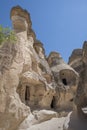 houses and churches carved in stone, in volcanic rock formations eroded by water, fairy chimneys, in the open-air museum of GÃÂ¶ Royalty Free Stock Photo