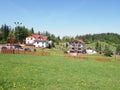 Houses in cool landscape of grassy field and forest at Beskid Mountains range european Salmopol village in POLAND Royalty Free Stock Photo