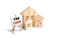 Houses and easel with FHA loan. Mortgage insured by Federal Housing Administration Loan. Affordable loans for borrowers with a low