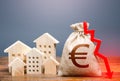Houses and euro money bag with down arrow. Reducing maintaining cost, energy efficiency, saving. Realty crisis. Low rates on Royalty Free Stock Photo