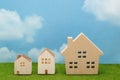 Houses on green grass over blue sky and clouds. Royalty Free Stock Photo