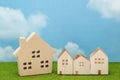 Houses on green grass over blue sky and clouds. Royalty Free Stock Photo