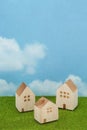 Houses on green grass over blue sky and clouds. Royalty Free Stock Photo