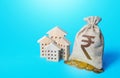 Houses and indian rupee money bag. Increasing property value. Fair market price. Home taxation. Residential or commercial property