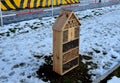 butterflies for moths and butterflies. in a city park on a housing estate in the winter stands in the snow road barrier