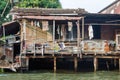 Houses at a klong in downtown Bangkok. Klongs are the canals, that branch off from Chao Phraya river, the big river of Bangkok Royalty Free Stock Photo