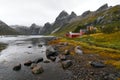 Panoramic view of a remote old fishing village at the coast in Vindstad with mountains in the background on Lofoten Islands Norway Royalty Free Stock Photo