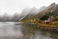 Panoramic view of a remote old fishing village at the coast in Vindstad with mountains in the background on Lofoten Islands Norway Royalty Free Stock Photo
