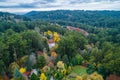 Houses among lush foliage in autumn.