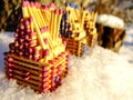 Houses of Matches standing on Snow