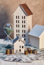 Houses models and hourglass on dollar