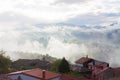 Houses with mountains in the fog in the background in Tineo, Asturias, Spain Royalty Free Stock Photo