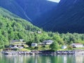 Houses, Norwegian village, fjord background on a Sunny day Royalty Free Stock Photo