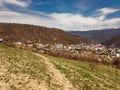 Houses on the outskirts of the city under a mountain covered with vegetation. Royalty Free Stock Photo