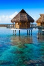 Houses over the transparent quiet sea water. Tahiti Royalty Free Stock Photo