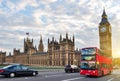 Houses of Parliament with Big Ben and double-decker bus on Westminster bridge at sunset, London, UK Royalty Free Stock Photo