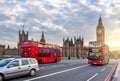 Houses of Parliament with Big Ben and double-decker buses on Westminster bridge at sunset, London, UK Royalty Free Stock Photo