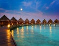 Houses on piles on water at night in fool moon light.Night tropical landscape