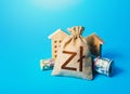 Houses and polish zloty money bag. Asset, financial resource management. Building up capital, saving from inflation risks. Real Royalty Free Stock Photo