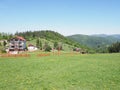 Houses in quite landscape of grassy field and forest at Beskid Mountains range european Salmopol village in POLAND