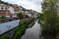 Houses reflecting in a river in the small town Aljezur, Algarve, Portugal Royalty Free Stock Photo