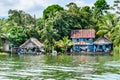 Houses on riverbank of Rio Dulce, Guatemala,