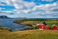 Houses on sea coast on cloudy sky in Torshavn, Denmark. Wooden houses on seascape. Beautiful landscape view. Summer Royalty Free Stock Photo