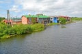 Houses with sheds on the river bank of Deyma. Polessk, Kaliningrad region Royalty Free Stock Photo