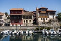 Houses and small parked boats in the port town of Llanes in Spain