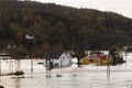 Houses standing in the deep water at Drangsholt. Flooding from the river Tovdalselva in Kristiansand, Norway - October 3
