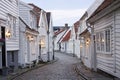 Traditional scandinavian cobblestone street with white houses in Stavanger, Norway