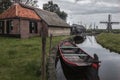 The houses, windmill and boat at the canal in the traditional old fisherman village open-air museum of Zuider Zee, Enkhuizen,