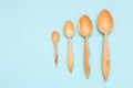 Houseware: wooden kitchen utensils, isolated on blue background top view. Zero waste, eco friendly concept. Flat lay