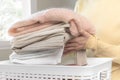 Housewife, asian young woman hand in many folding freshly shirts put the cloth in the basket after washing clean clothes and Royalty Free Stock Photo